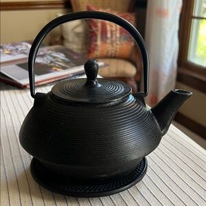 Vintage Stovetop Black Cast Iron Used Teapot with trivet.